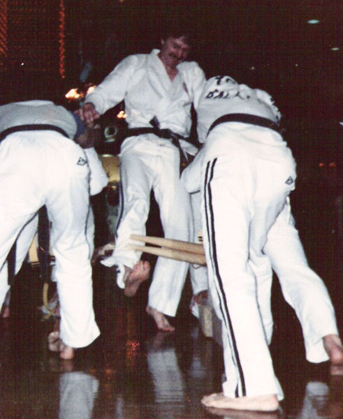 Sensei Dugan breaking two wooden baseball bats with his shin